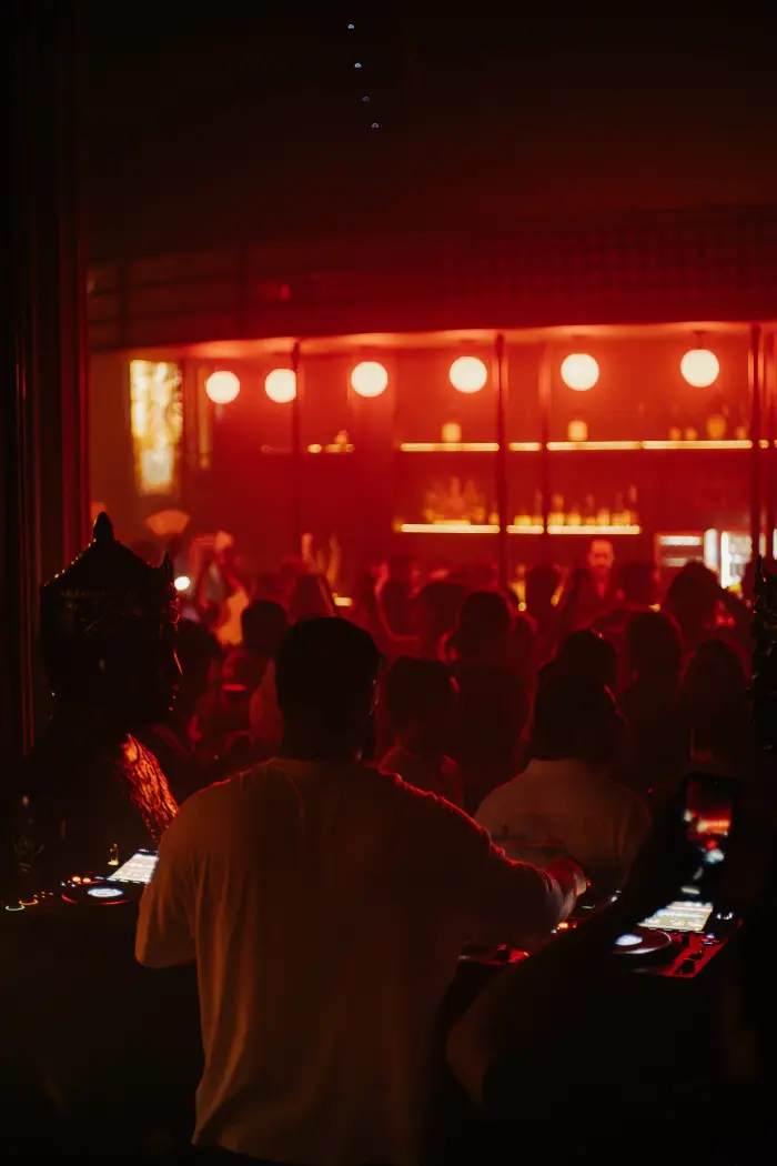 Crowd at the Mandala Cancun bar under red lights